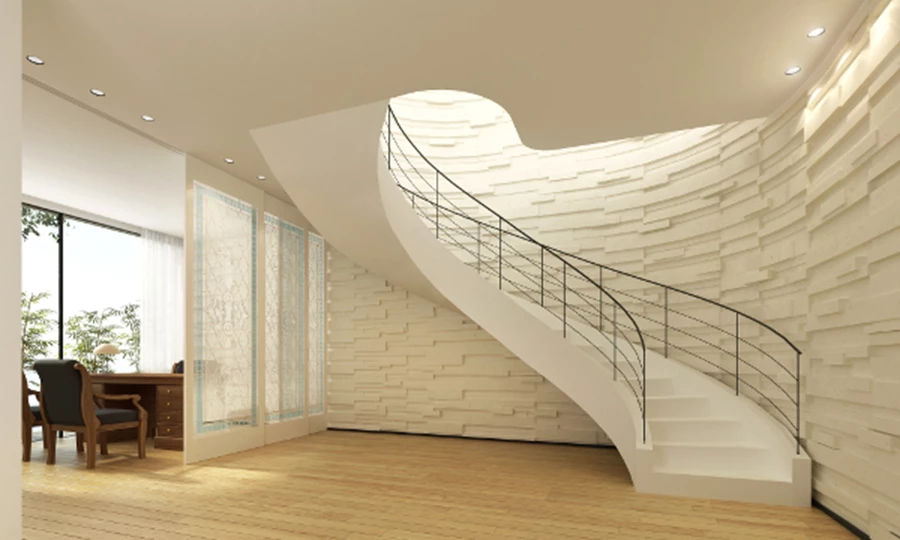 דירת גג דו-מפלסית במרכז תל אביב - גרם מדרגות פיסולי על רקע קיר בחיפוי אבן מקומית במידות ועוביים שונים.